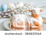 Easter lamb cake eggs and catkins on blue background