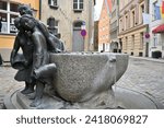Small photo of Stralsund, Germany - April 14, 2023: City sclupture - "The Garrulous Women" at old town of Stralsund, sculptor Gunter Kaden.