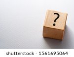 Natural wooden cube or dice with question mark