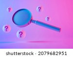 Small photo of Studio close-up of an old magnifying glass floating between spheres with question marks against purple background as symbol for research and complicated investigations