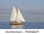 Tender With White Sails In The...