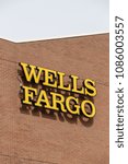 Small photo of Lancaster, PA, USA - May 5, 2018: Exterior sign of Wells Fargo bank at one of its 8300 branch offices.