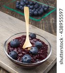 Small photo of bowl with jam and blueberries, on lackluster wood