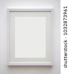 blank photo frame at the wall | Shutterstock . vector #1032873961