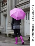 Woman Wearing A Pink Umbrella...