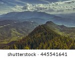 Beautiful panoramic scenery with Bucegi mountains range at the horizon, as seen from the Postavaru massif in Brasov county, Romania. Romanian travel destinations, touristic attractions.