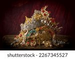 Small photo of Romantic image of a treasure chest filled with jewellery, precious gems and golden king's crowns
