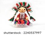 Colorful traditional Mexican rag handmade doll isolated in white.
Doll with long braids and ribbons using the colors of the Mexican flag.