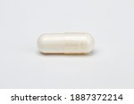 closed up of a transparent pill filled with white ingredient