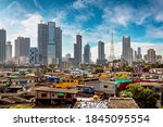 Small photo of Views of slums on the shores of mumbai, India against the backdrop of skyscrapers under construction