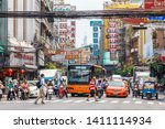 Small photo of Bangkok, Thailand - March 23rd 2015: People crossing in front of traffic in Chinatown. Traffic is notoriously bad in the city.
