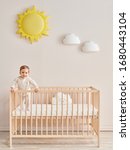 Small photo of Baby in the wooden cradle and crib style, modern room and toy in the pink wall.