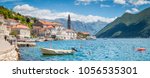 Scenic panorama view of the historic town of Perast located at world-famous Bay of Kotor on a beautiful sunny day with blue sky and clouds in summer, Montenegro, southern Europe