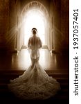 Small photo of Bride Back Side View walking down Aisle Church. Woman In Window Door Light. Wedding Ceremony Day. Bridal Dress long Train and Lace Veil. Indoor Art Portrait