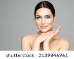 Beauty Woman Face Skin Care. Beautiful Woman Portrait with Full Lips and Long Eyelashes over Gray. Hands Manicure and Facial Treatment Cosmetics. Spa Massage and Face Lift Cosmetology