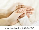 Family Baby Hands. Father and Mother Holding Newborn Kid. Child Hand Closeup into Parents