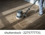 Small photo of Professional worker with parquet polishing grinding machine