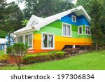 Beautiful colorful house and big tree in forest