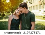 Small photo of A happy woman with her almost adult son, a teenager, spend time together and laugh, recall funny situations from their lives, the focus is on mother. A real portrait of a mother and son
