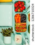 Small photo of Creative flat lay with healthy lunch and office or school supp