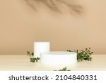 Small photo of Two Abstract empty white podiums with eucalyptus leaves on beige background. Mock up stand for product presentation. 3D Render. Minimal concept. Advertising template
