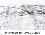 Snowy winter city road with tire trace.