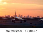 airplane before New York skyline, at departure, at sunset