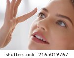 Small photo of Eye care. Smiling Woman With Contact Lens on Finger Closeup. Smiling Lady with Contact Eye Lenses in Hand. Girl Applying Eye Contacts. Eye Health Care Concept