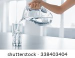 Drink Water. Woman's Hand Pouring Fresh Pure Water From Pitcher Into A Glass. Health And Diet Concept. Healthy Lifestyle. Healthcare And Beauty. Hydratation.