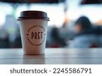 Small photo of Pret A Manger cup of coffee on the terrace of a coffee shop in London, 2023.