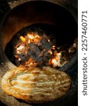 Small photo of Cooking tandir bread (traditional Azeri bread) in a naan fire oven. Traditional food of Azerbaijan.