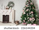 Image of chimney and decorated xmas tree with gift