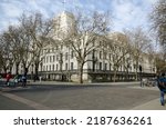 Small photo of London, UK - March 21, 2022: View from Montague Place looking at the imposing headquarters of the University of London - Senate House in Bloomsbury. Pedestrians are walking in the sunshine.
