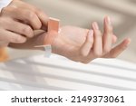 Small photo of Wounded hand of woman, first aid treated with elastic bandage, closeup shot