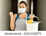 Happy smiling successful Asian immigrant cleaning service worker woman, concept image of domestic helper holding cleaning supplies, ready for work