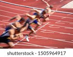 blurred start of athletic runners in sprint