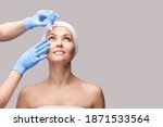 Small photo of Girl with eye drops. Doctor hands applying eyewash. Recovery cataract procedure. Conjunctivitis treatment. Health ophthalmic concept. Ophthalmology clinic. Anti allergic drug. Grey background