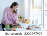 Small photo of Fat woman are determined to lose weight, by learning to cook healthy food from video clips on the laptop, eating concept for weight loss and health