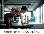 Small photo of Fitness girl lifting dumbbell weights at the gym, doing exercises with dumbbell, fitness muscular body