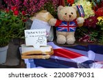 Small photo of London, UK - September 9th 2022: Marmalade Sandwich, Teddy Bear and Flowers left by well-wishers at Buckingham Palace in London, in commemoration of Elizabeth II, who died the previous day.