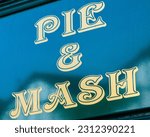 Small photo of A Pub and Mash sign. Pie and Mash is a traditional Cockney classic consisting of a minced beef pie, mashed potato and a parsley sauce known as liquor.