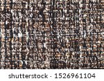 textile square background - interlacing of threads in motley boucle fabric close up