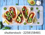 Small photo of Jack fruit vegan tacos. Top down view table scene over a rustic blue wood background. Healthy eating, plant-based pulled pork meat substitute.