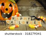 Happy Halloween wooden blocks with candy corn and decor against an old wood background