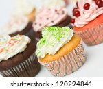 group of multicolored ornate details muffins white background