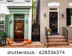 Traditional Wooden Front Doors of Old Coloured Brick Buildings with Halloween Decorations