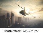 Silhouette of three army helicopters doing patrols while flying over downtown, shot at sunset time