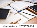 Small photo of Closeup pencil on the notebook with many opened books on the desk, editing or rewrite the information from many reference book to create a new content
