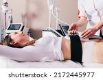 Small photo of Woman getting treatment on abdomen to burn fat and build muscles, slimming technology