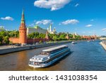 Moscow center in summer, Russia. Famous Moscow Kremlin is a top tourist attraction of city. Scenic view of the Moscow landmark and ship on Moskva River. Concept of travel and vacation in Moscow.